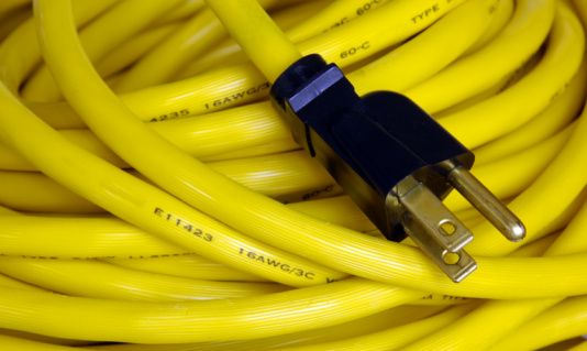 Netwrok cables plugged into a server for fast communication network services in a warm and blue surrounding.