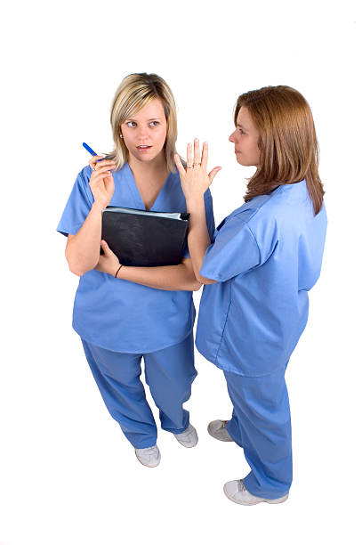 Nurses Gossip About A Doctor stock photo