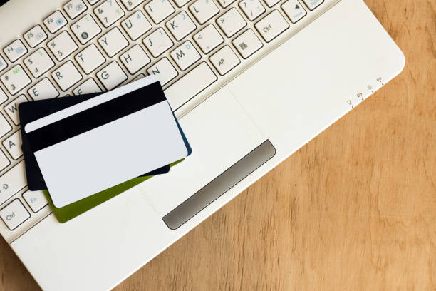 istock Laptop keyboard and credit cards top view. 967650912