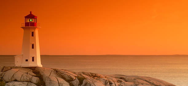 Peggy's Cove Lighthouse at sunset stock photo