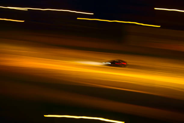 Fast car driving on a night street. Blurred motion. stock photo