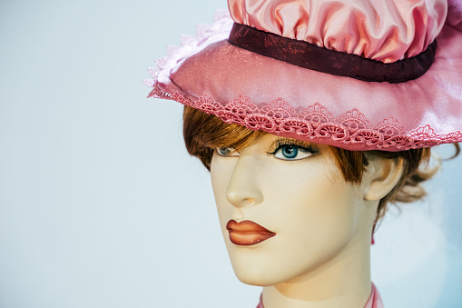 Close-up of a plastic mannequin head in a pink hat