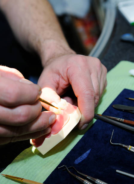 istock Laboratory dentist technician working on prostetic tooth close 967672970