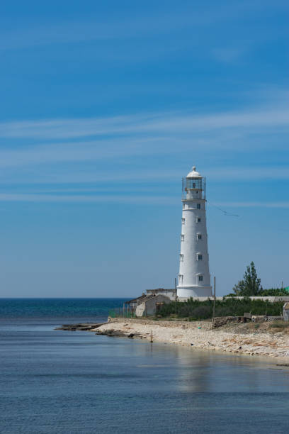istock seascape with beautiful white lighthouse on blue sky background. 967677760