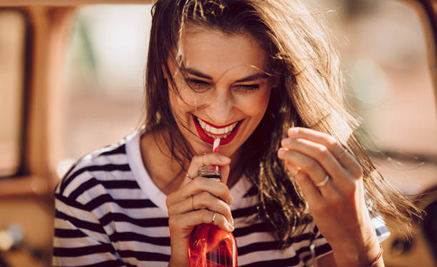 istock Beautiful young woman drinking soda 967678548