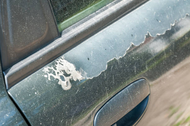 istock Blue car doors with damaged and peeled paint and lacquer close up selective focus 967688116