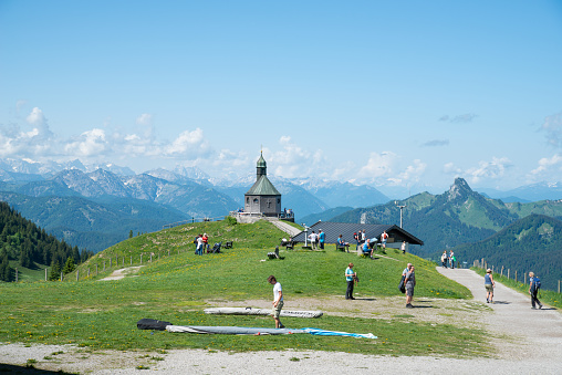 Kapelle on Wallberg near lake Tegernsee. View from mountain side. Hiking people visible.