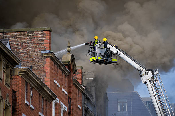 British Firemen in Action (close)  extinguishing stock pictures, royalty-free photos & images