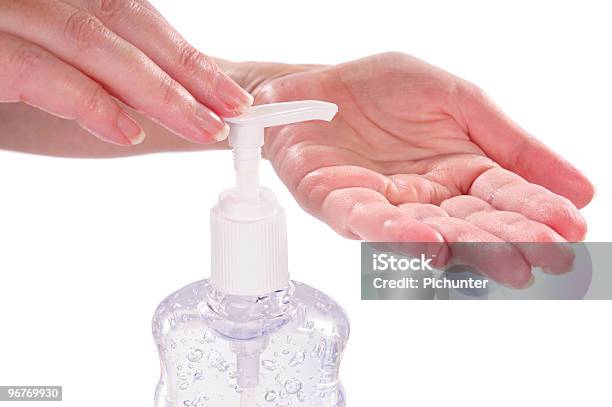 Woman Sanitizing Her Hands With Germ Protection Stock Photo - Download Image Now - Adult, Bottle, Cleaning Equipment