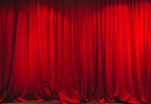 Red curtain in theater on stage.