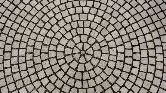 Center view of patio pavers circle design overhead view, Old mosaic from granite at a street