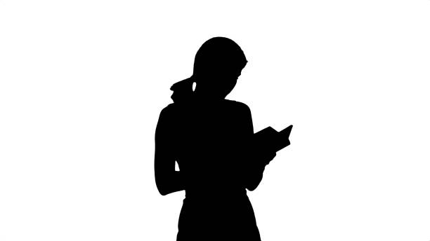 Silhouette Young girl with book on laptop. Professional shot on BMCC RAW with high dynamic range. You can use it e.g in your commercial video, business video, office theme.