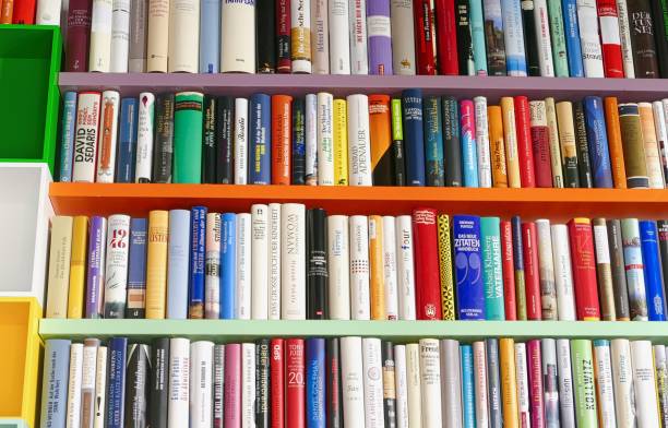 istock Library with many books and empty colorful shelfs 967721216