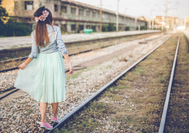 istock Girl walks the train tracks 967723712
