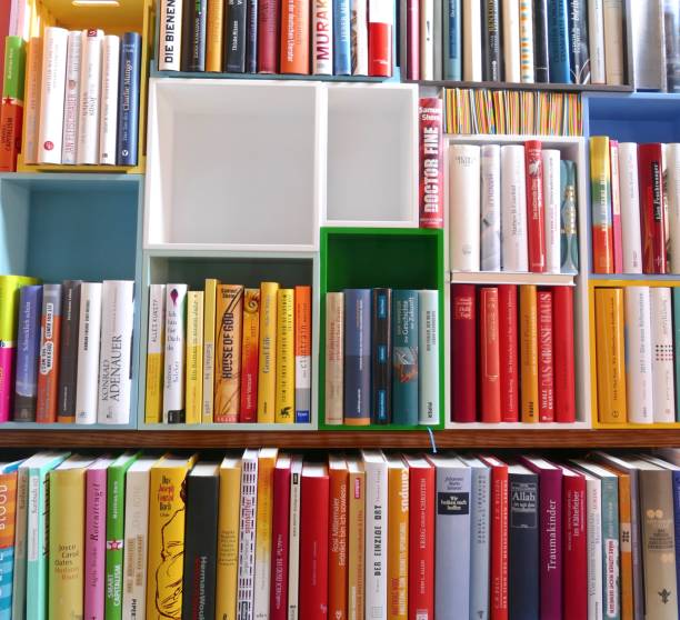 istock Library with many books and empty colorful shelfs 967723874