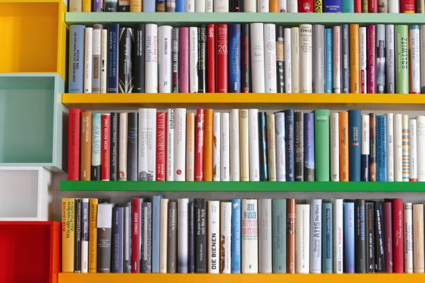 istock Library with many books and empty colorful shelfs 967723982