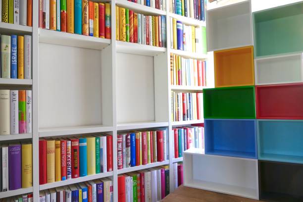 istock Library with many books and empty colorful shelfs 967724116