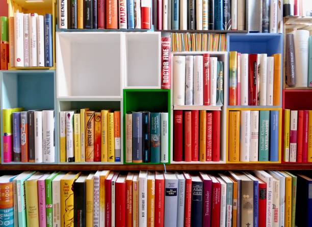 istock Library with many books and empty colorful shelfs 967724432