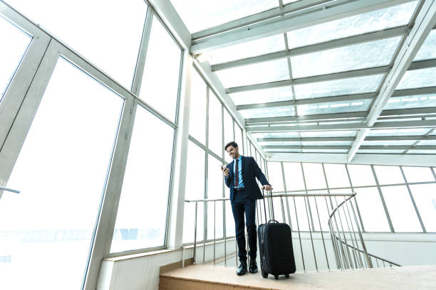 istock Businessman with suitcase at airport 967724482