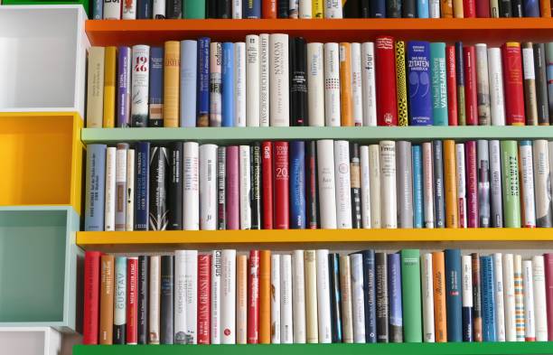 istock Library with many books and empty colorful shelfs 967724580