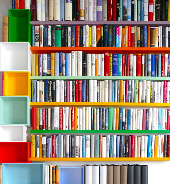 istock Library with many books and empty colorful shelfs 967724946
