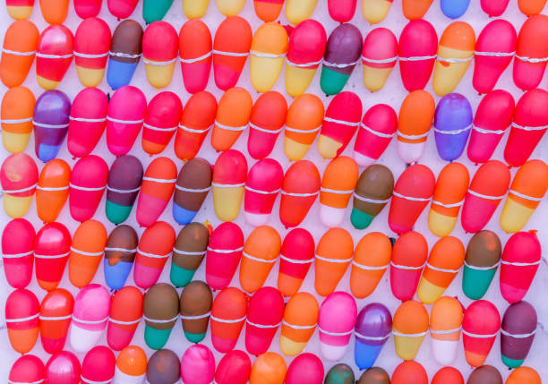 balloons tied on a board for kids to fire and burst the balloons