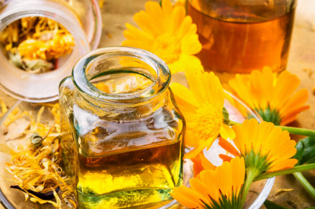 istock Medicine bottle and herbs calendula 967728366