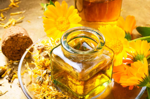 istock Medicine bottle and herbs calendula 967728412
