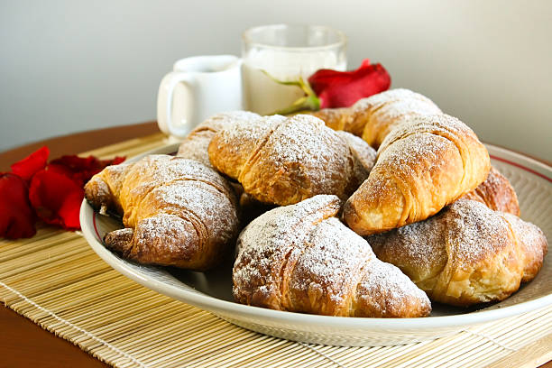 Croissants with Red Rose composition stock photo