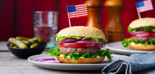 istock Burger on a plate with pickles. Wooden background. 967728622