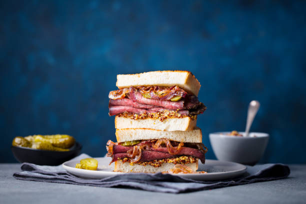 istock Roast beef sandwich on a plate with pickles. Copy space. 967728904