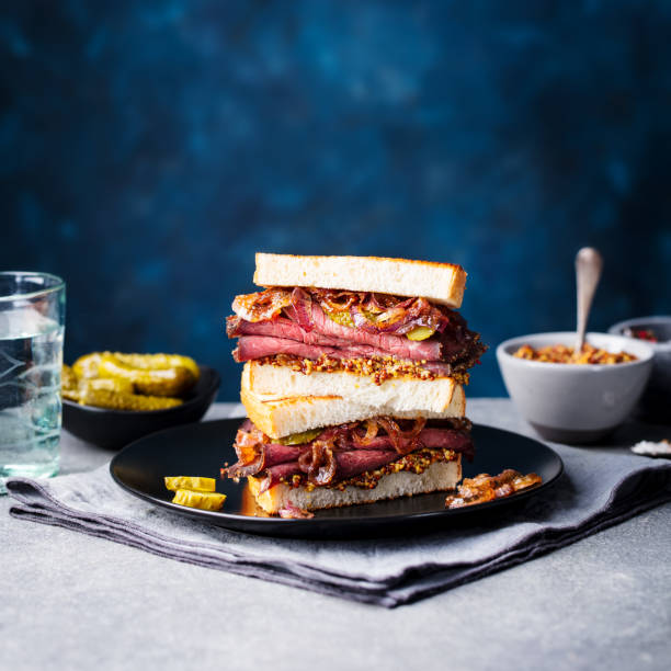 istock Roast beef sandwich on a plate with pickles. Copy space. 967729010