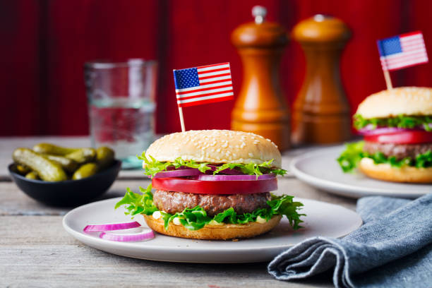 istock Burger on a plate with pickles. Wooden background. 967731962