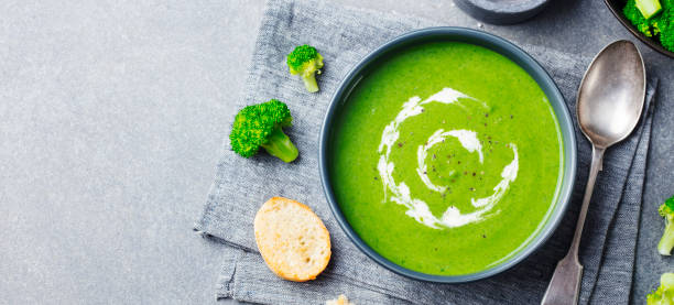 istock Broccoli cream soup in a bowl with toasted bread. Top view. Copy space. 967732594