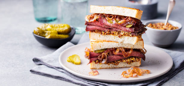 istock Roast beef sandwich on a plate with pickles. 967732728