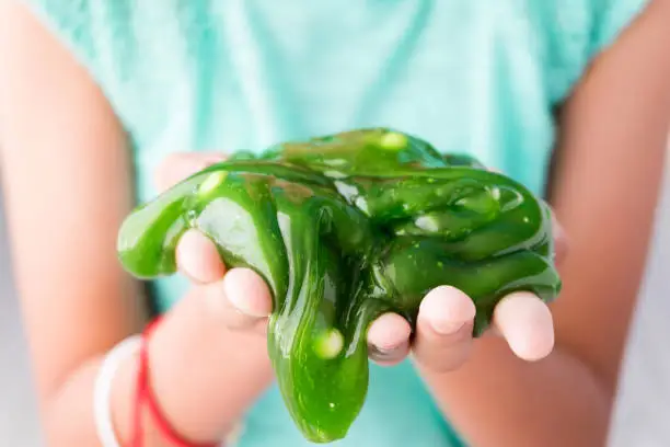 Photo of Colorful of Homemade Toy Called Slime, Kids having fun and being creative by science experiment.