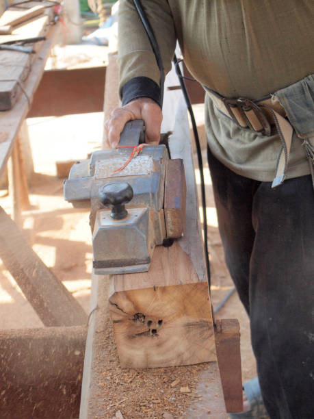 istock carpenter working with plane on wooden background 967744484