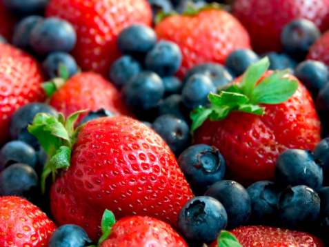 August photo with lingonberries, blueberries and raspberries picked in the forest (Torne Valley, Sweden)