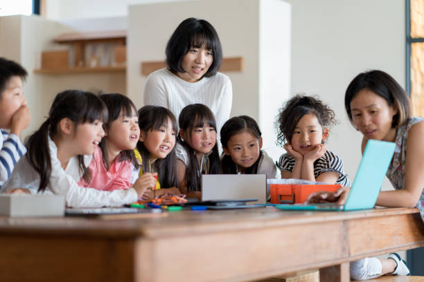 istock Teacher explaining a project to a group of young students 967751562