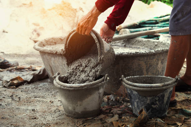 istock worker pouring cement mix concrete in tray 967760060