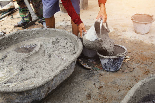 istock worker pouring cement mix concrete in tray 967760066