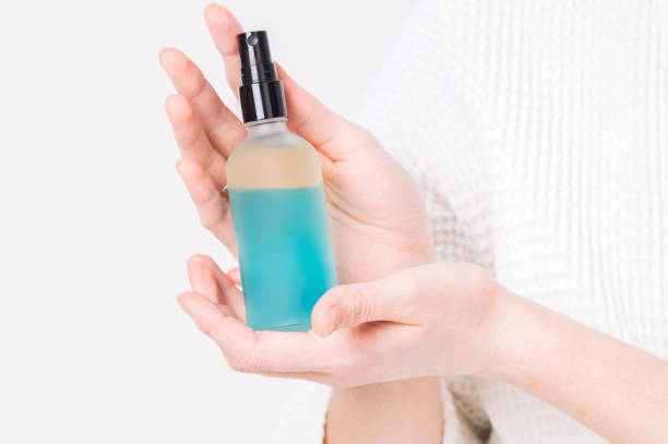 istock Cosmetic: the girl shows in her hands a small bottle with a blue liquid without a label. 967765514