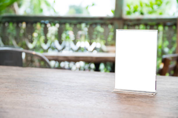 istock mock up menu object in cafe and restaurant,blank screen for booklet with white sheets of paper on wooden table on cafeteria,copy space for text or graphics object 967765678