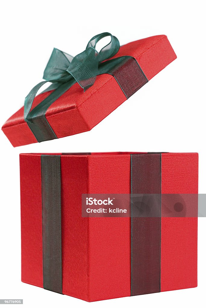 A red gift box with the lid open and a green bow A festive gift box with it's lid blasting off the top! Open Stock Photo