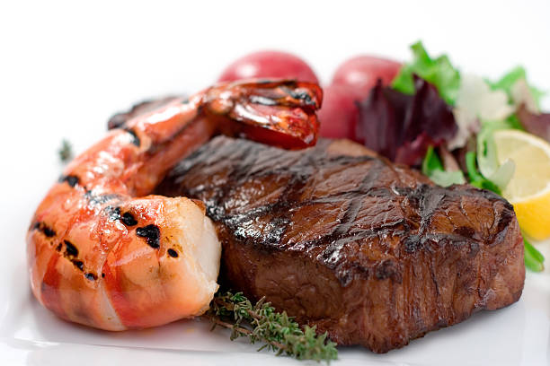 Surf and turf seafood dinner on plate stock photo