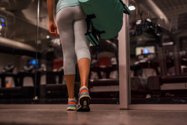 istock Close up of unknown female walking in gym. 967770626