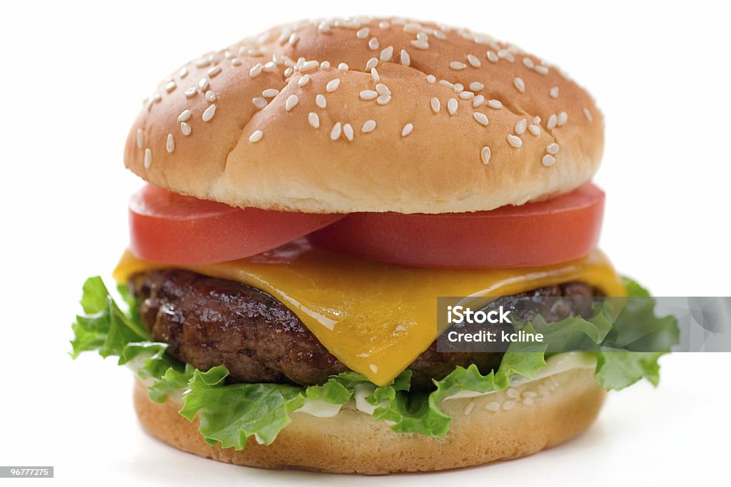 Close up of restaurant style cheeseburger Delicious juicy cheeseburgery goodness with lettuce, tomato, cheese and mayo.  Shallow dof, focus at the front of the burger. Not isolated, shot in studio on white. Hamburger Stock Photo