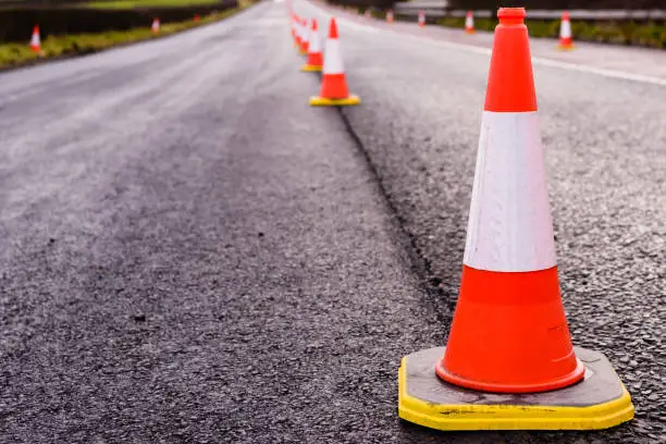 Photo of Row of traffic cones along the middle of a road being resurfaced.