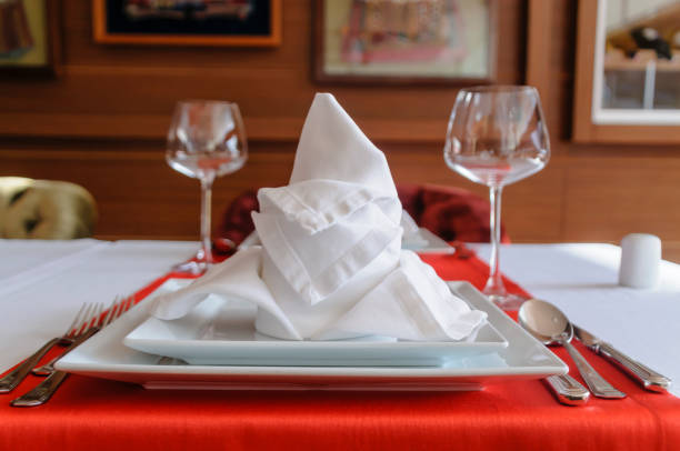 istock Folded napkin and place settings in a fine dining restaurant 967773362