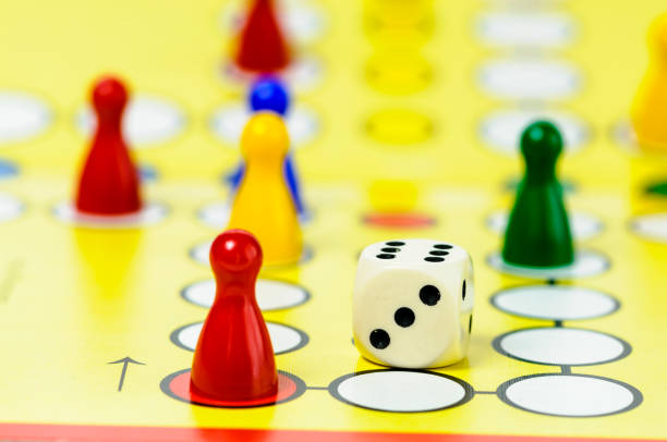 istock Pieces and a die on a Ludo board game 967773506